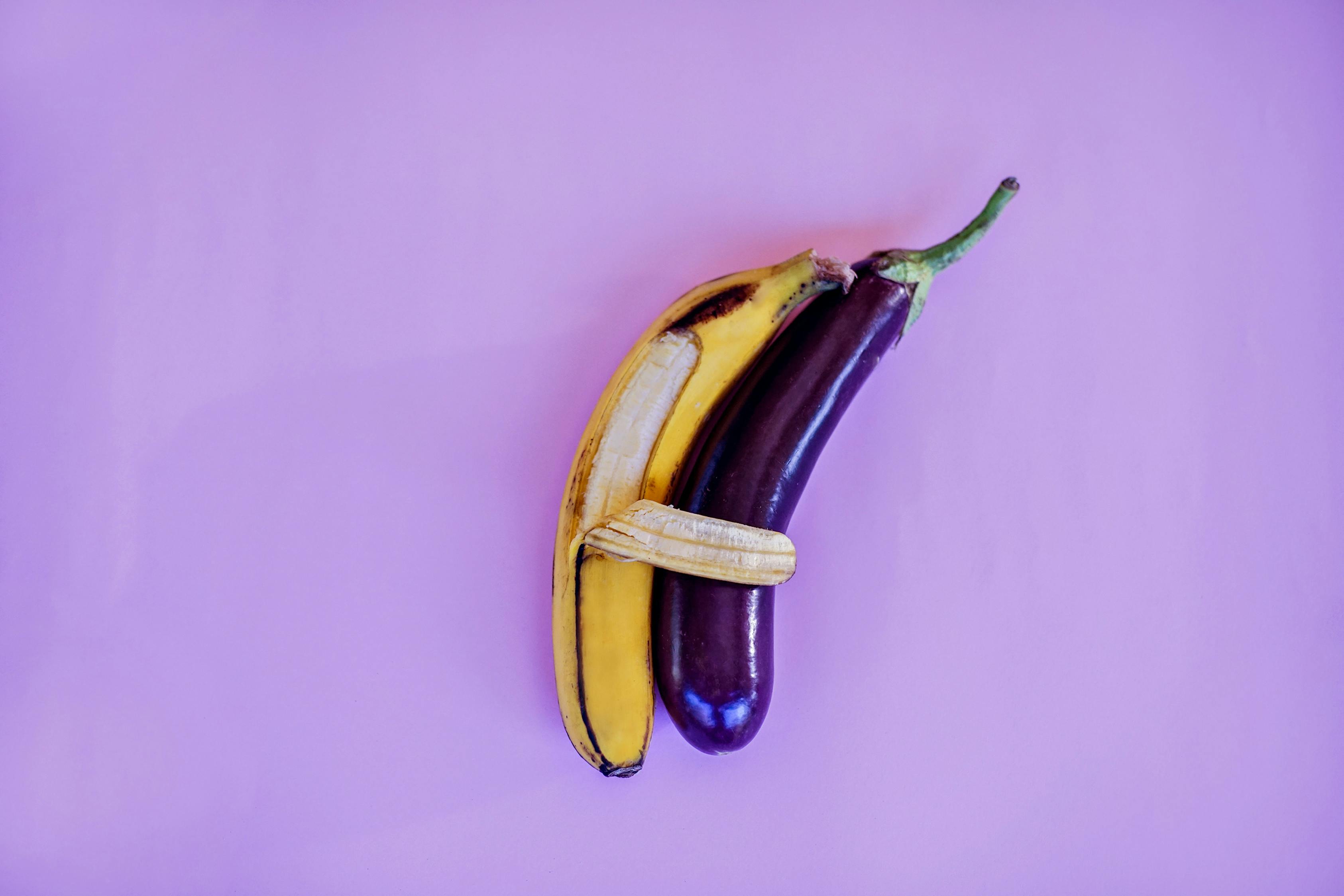 Banana and Eggplant on Violet Surface