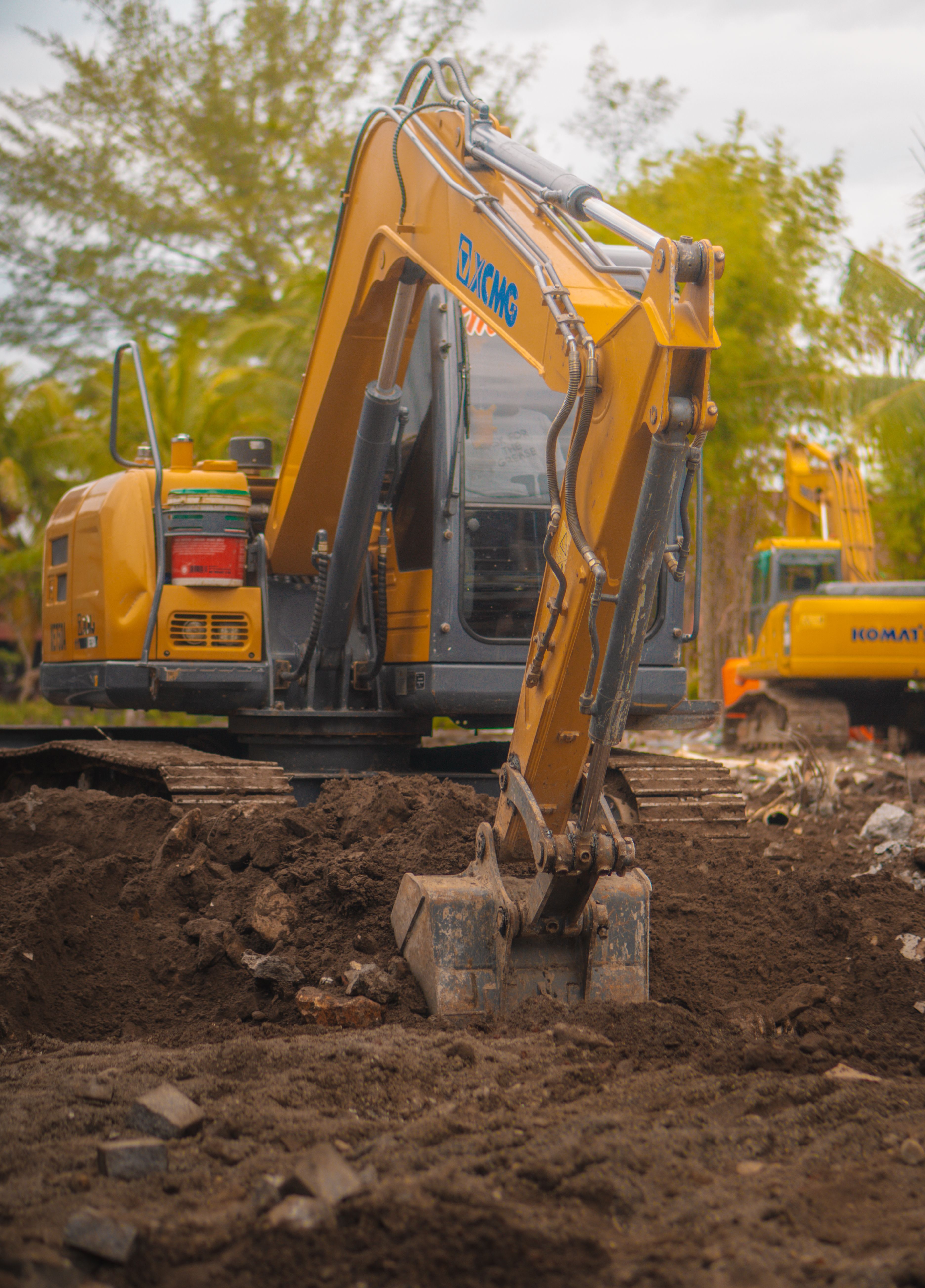 Yellow excavator operating at a construction site in Makassar, Indonesia.