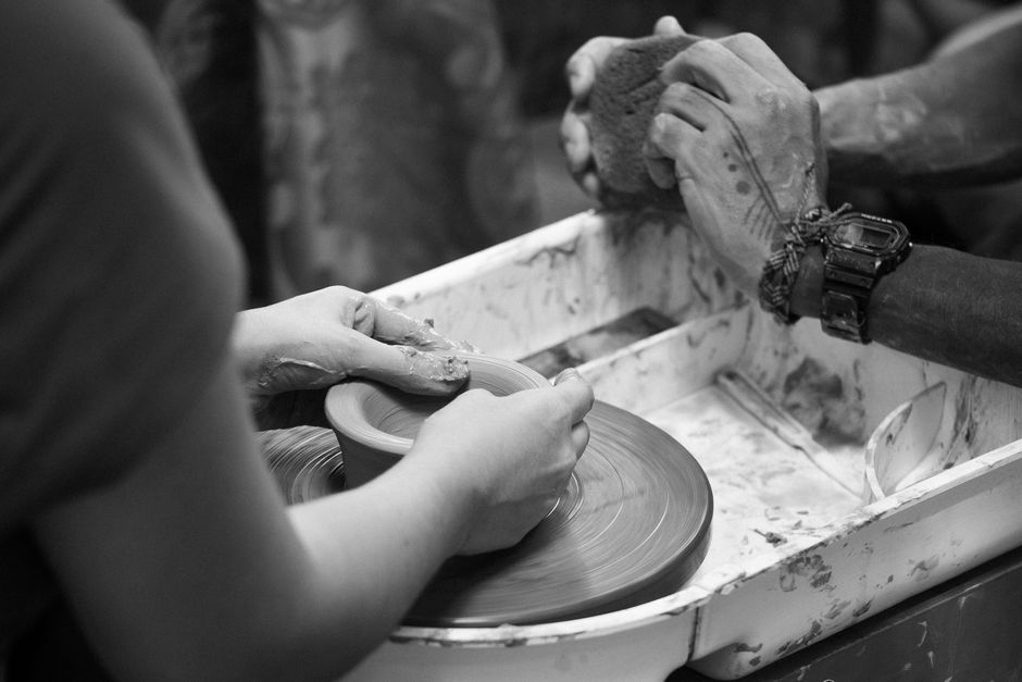 potter shaping clay wheel