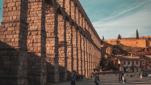 Free The stunning ancient Roman aqueduct in Segovia, Spain, under warm daylight. Stock Photo