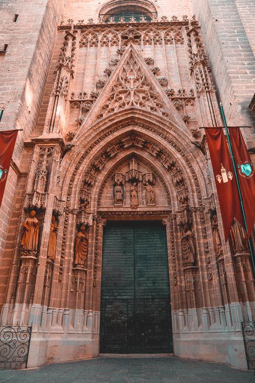Free Ornate Gothic entrance of Seville Cathedral in Andalusia, Spain, showcasing intricate carvings. Stock Photo