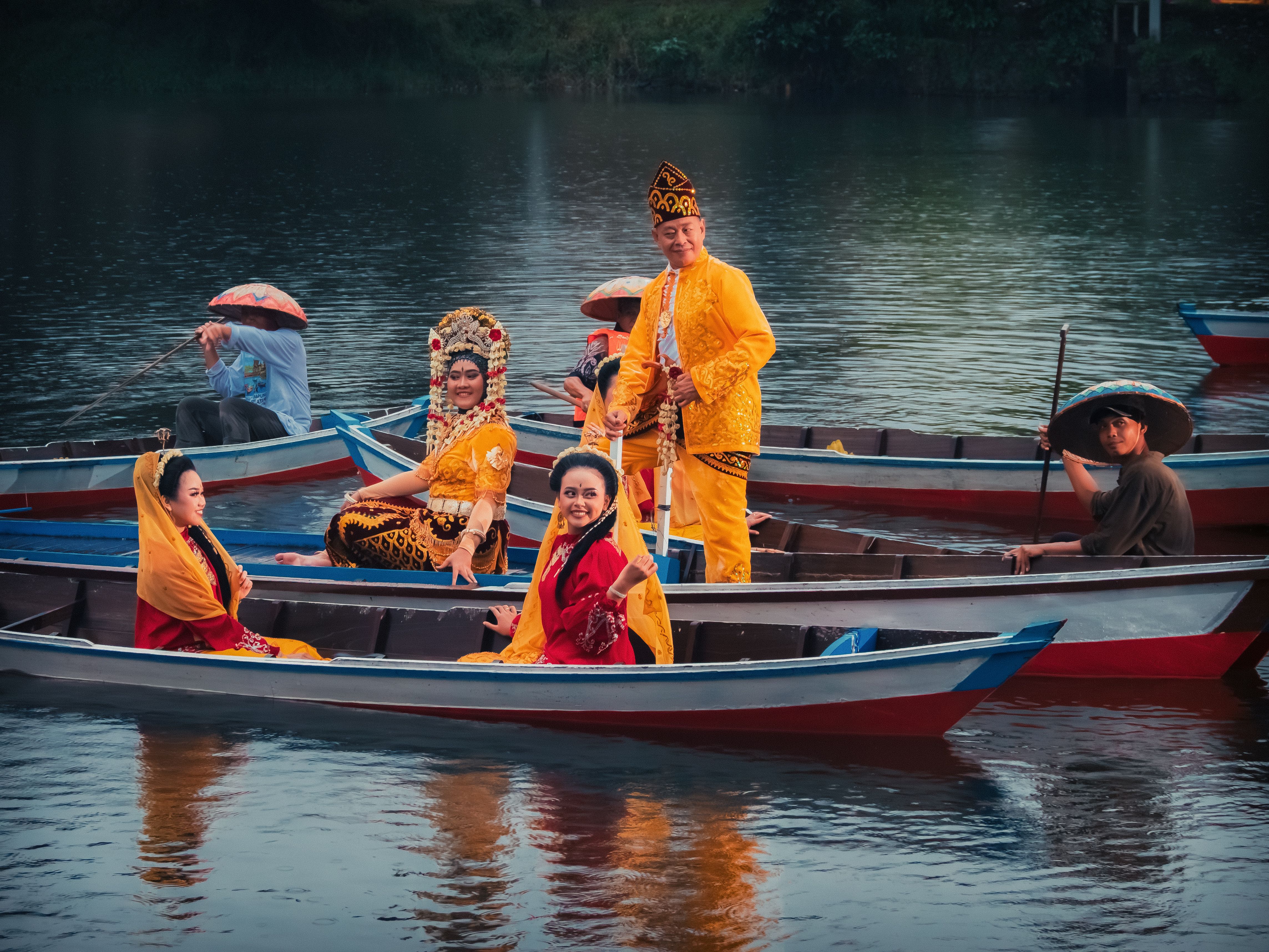 A colorful group in traditional attire, enjoying a boat ride in Jakarta, Indonesia.