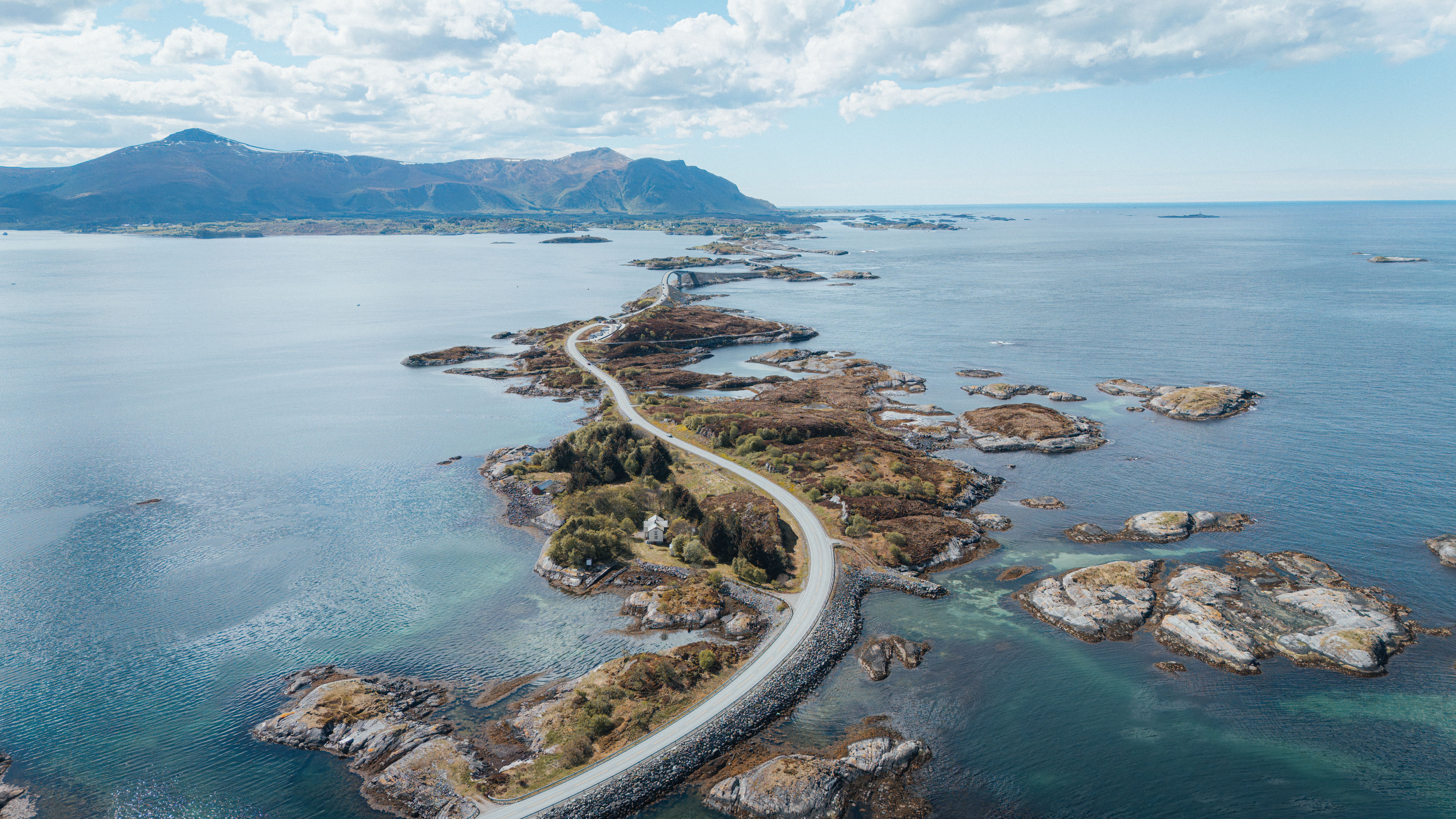 Stunning aerial view of the winding Atlantic Ocean Road, bridging islands amid the scenic Norwegian coast.