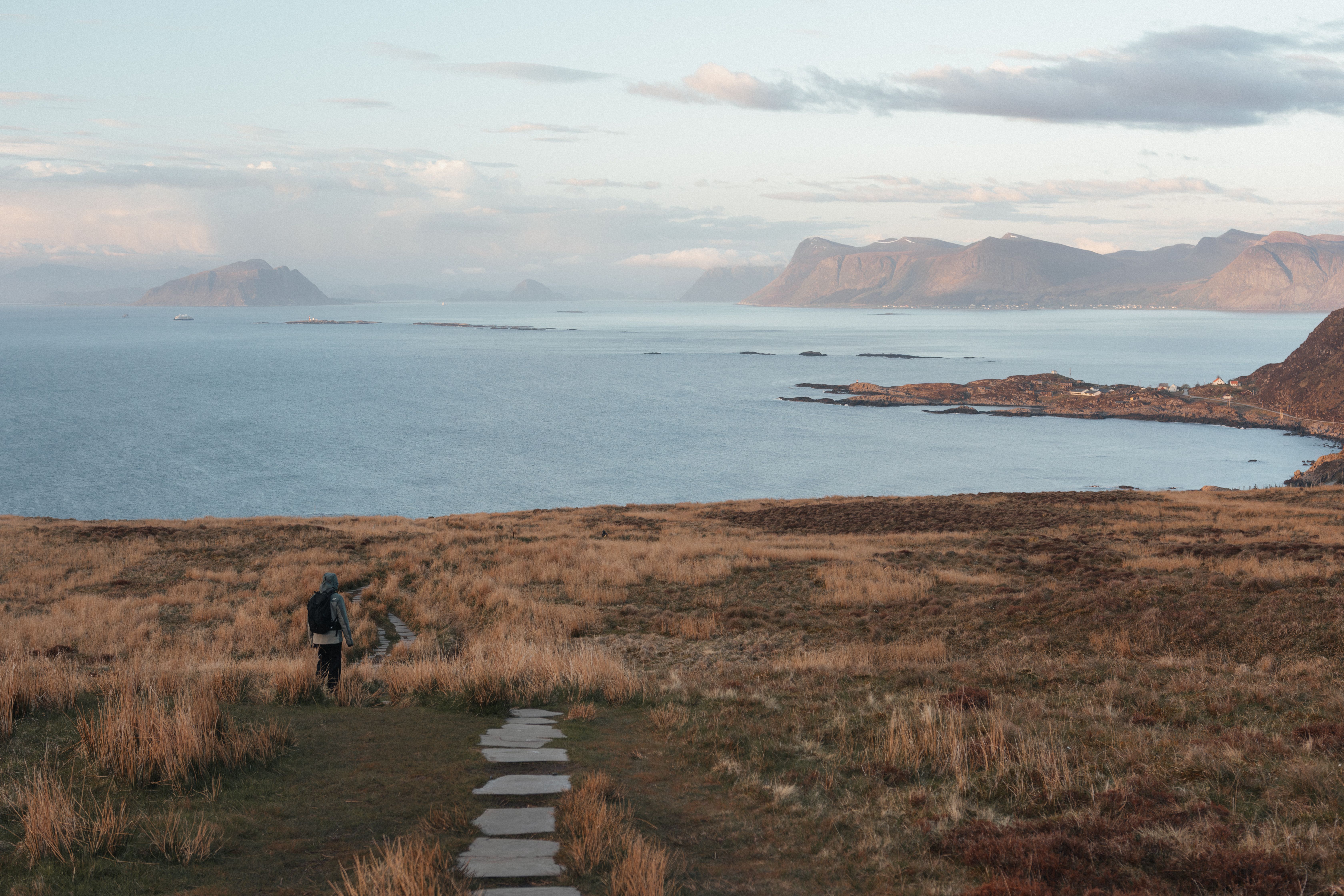 A tranquil hiking path leads to breathtaking coastal vistas of Runde, Norway.