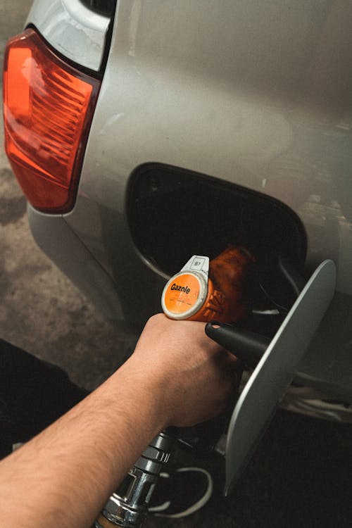 Free Person Refilling Gasoline on Gas Tank Stock Photo