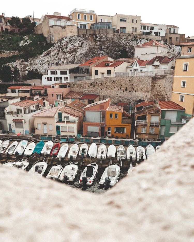 Speedboat Docked Near Concrete Houses