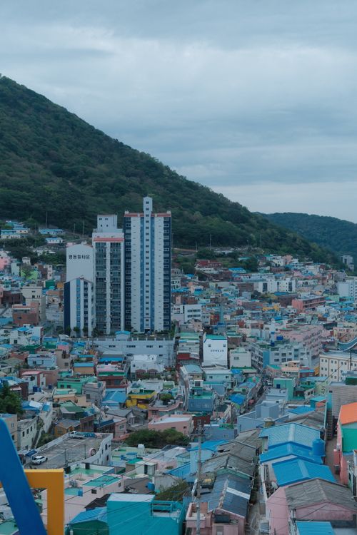 Free Vibrant aerial view of the colorful Gamcheon Culture Village in Busan, South Korea, nestled against a lush hillside. Stock Photo