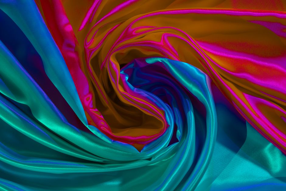 A vivid swirl of colorful fabric creating an abstract and dynamic background.