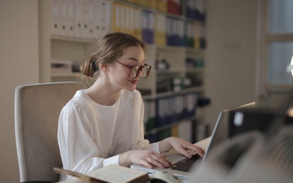 Young woman working through an SEO task on her laptop in an office