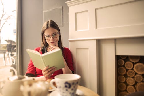 Free Woman Wearing Eyeglasses Reading Book Stock Photo