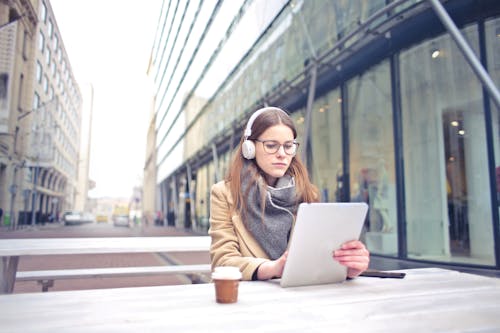 Woman In Brown Coat Wearing Headset