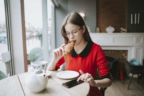Free Woman In Red And Black Long Sleeve Holding A Bread Stock Photo