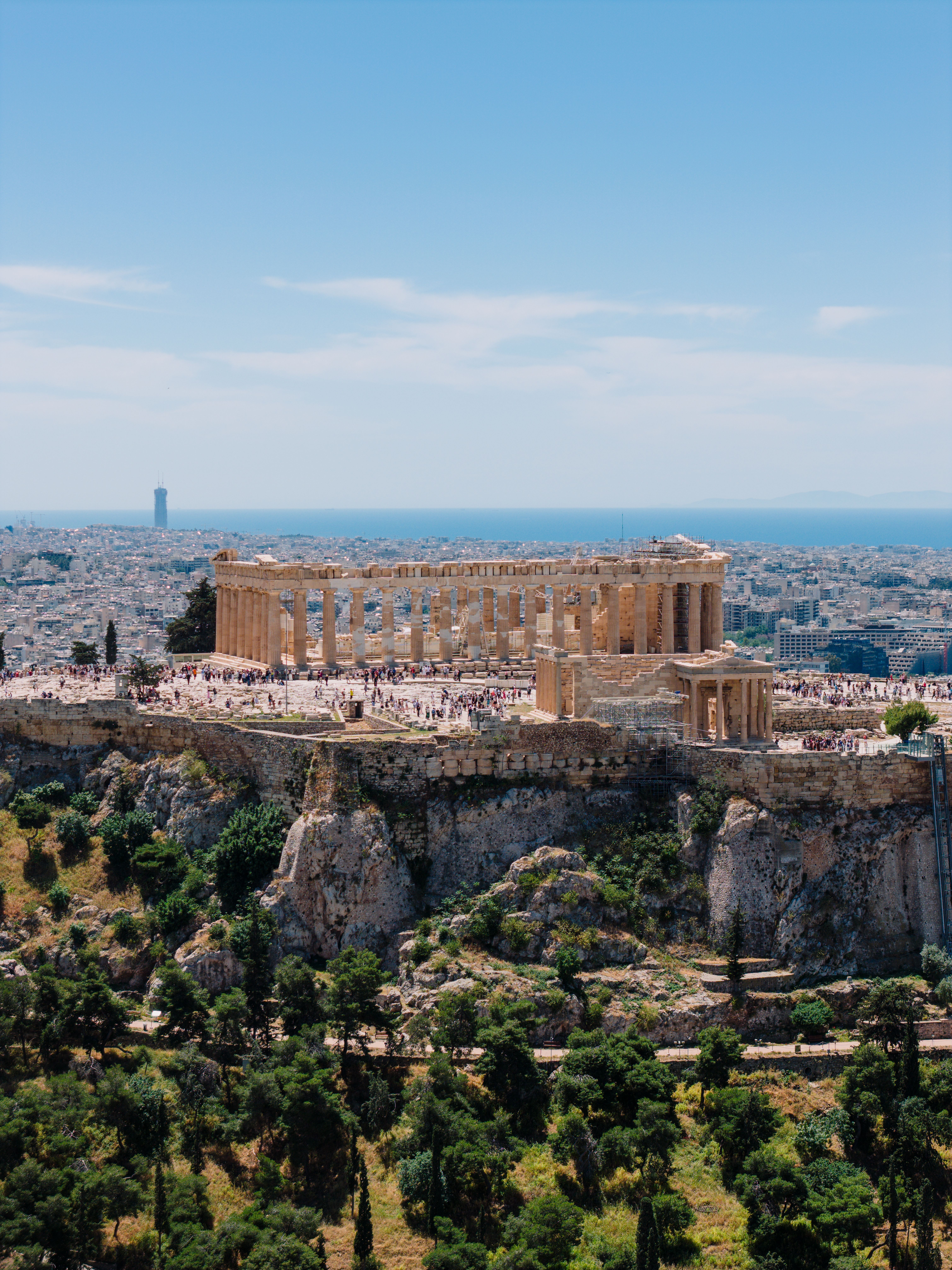 Stunning aerial view of the Parthenon atop the Acropolis in Athens during a sunny day.
