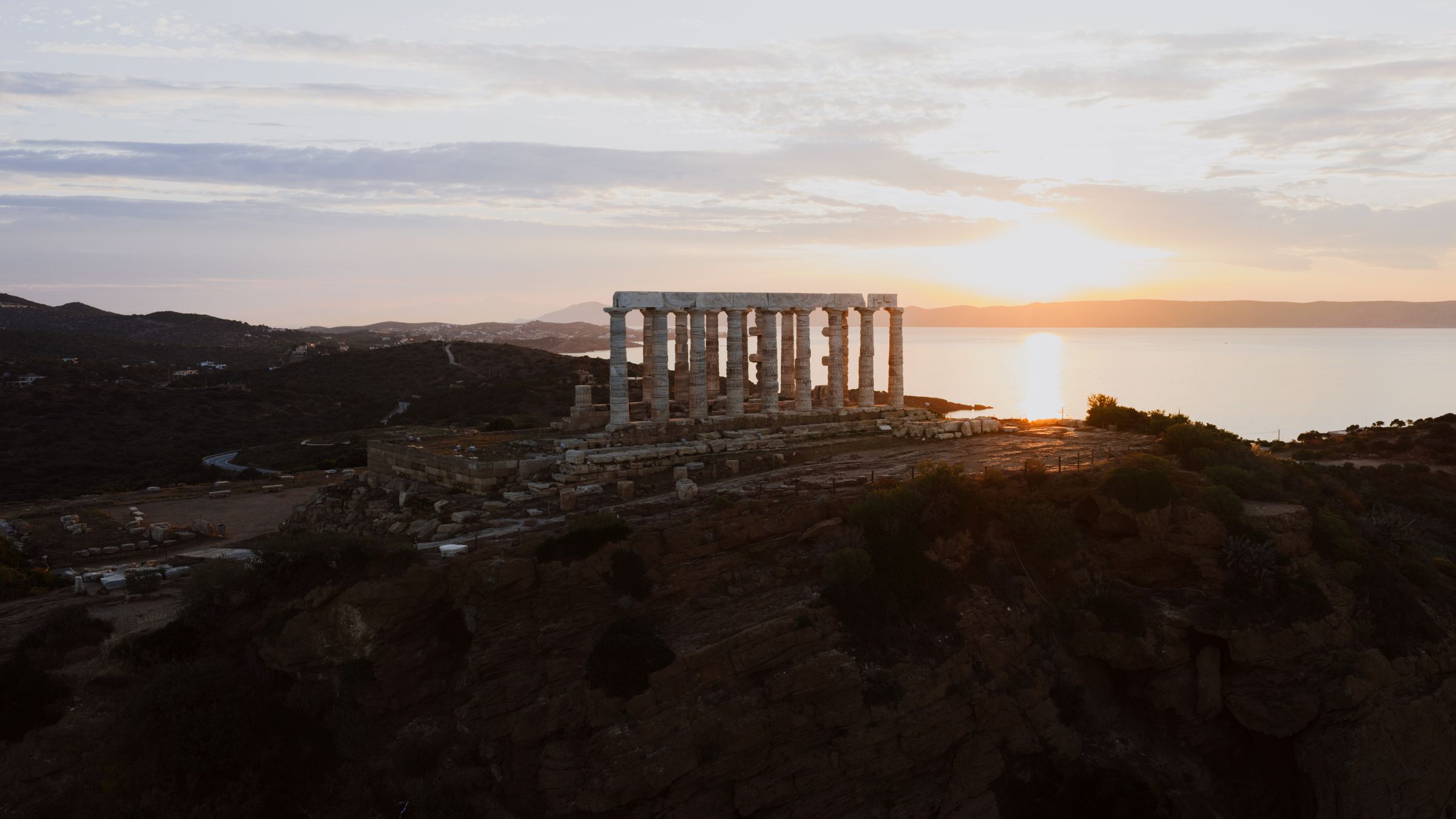 Temple of Poseidon at Cape Sounion overlooking the Aegean Sea at sunset