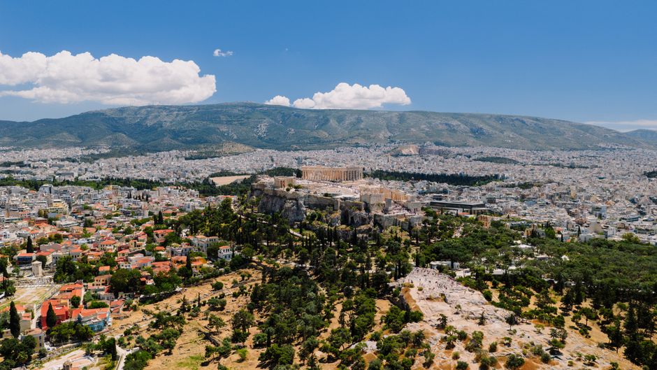 Stunning Private Helicopter Transfer from Mykonos to Santorini Review 2026 - Stunning aerial view of the ancient Acropolis in Athens, Greece amidst the cityscape.