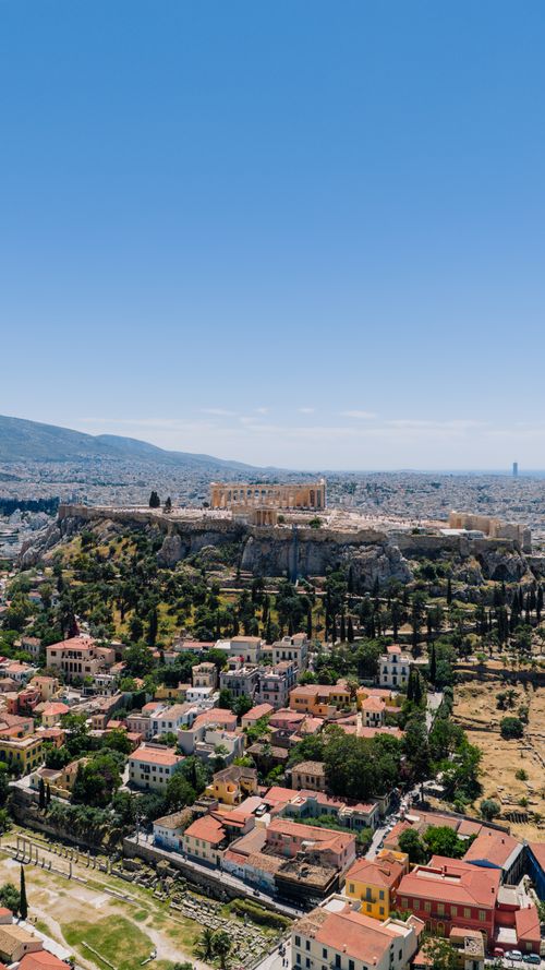 Free Stunning aerial view of the Acropolis and Athens cityscape under a clear blue sky. Stock Photo