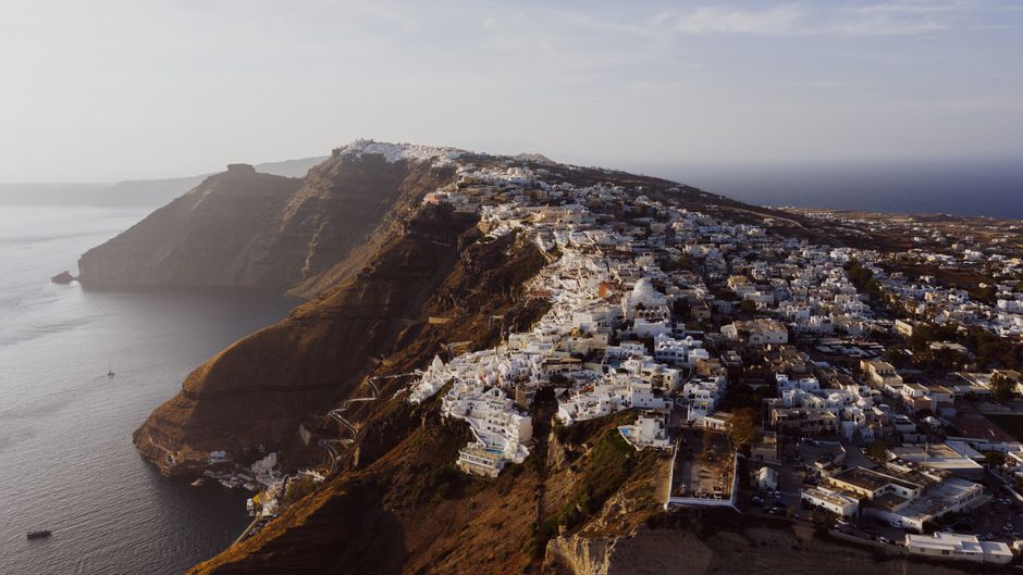 A local bus waiting at a station in Fira, Santorini, Greece