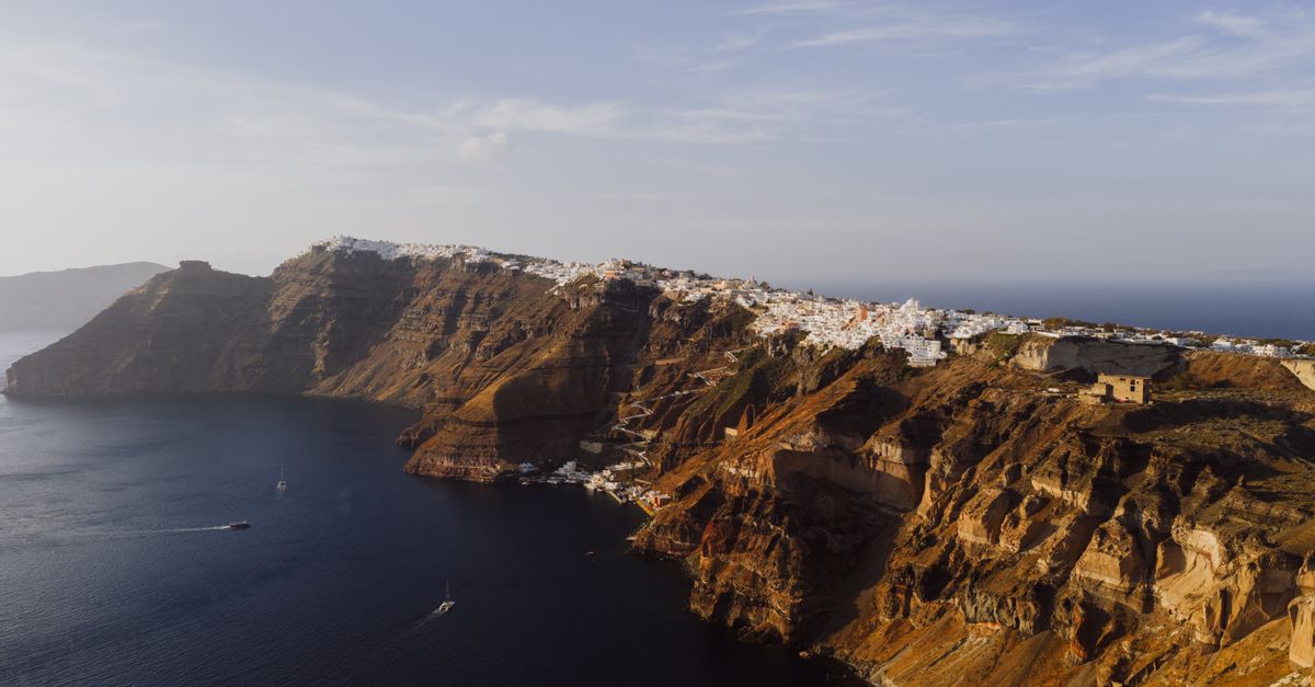 Santorini caldera rim hiking trail with white-washed villages