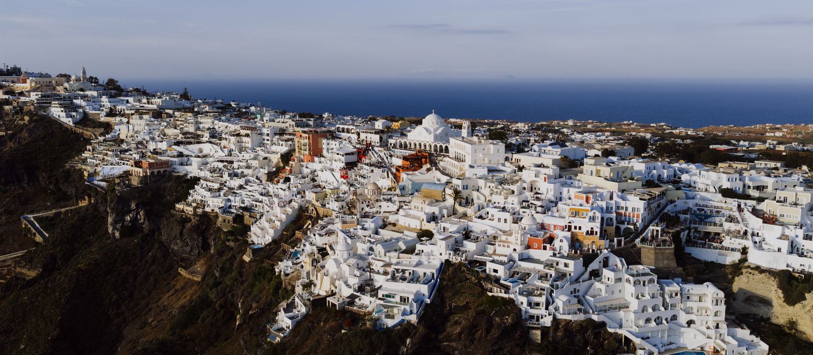 Stunning aerial view of Fira's iconic white architecture against the Aegean Sea.
