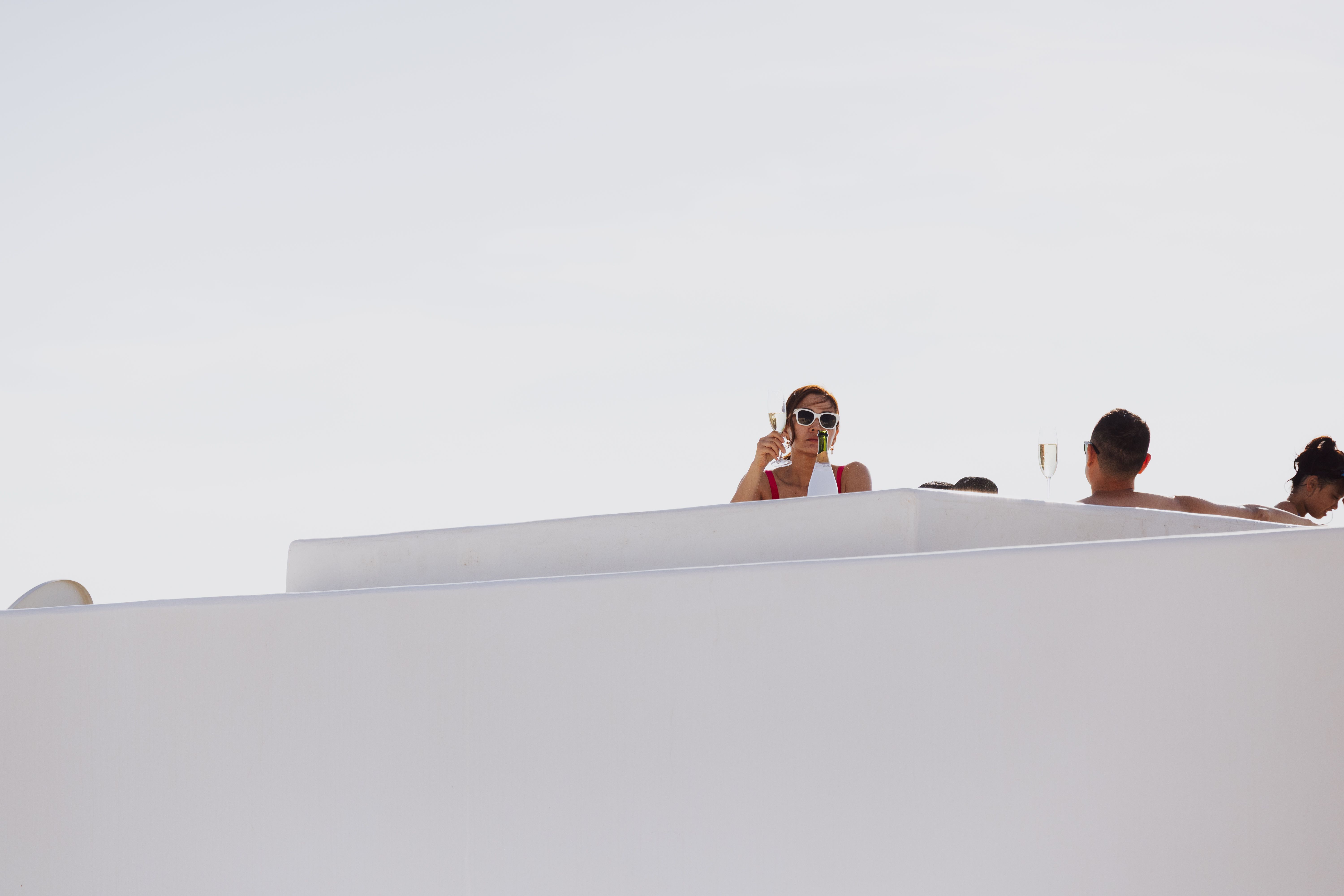 A minimalist, serene view of a private luxury retreat overlooking a tranquil, untouched natural landscape.