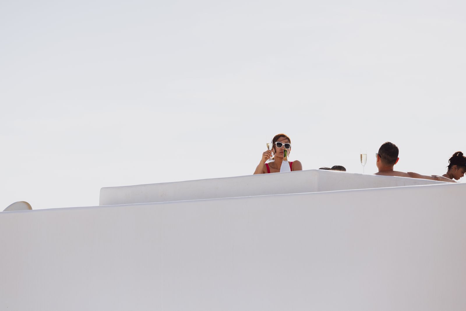 Couple wine tasting Santorini Oia caldera sunset
