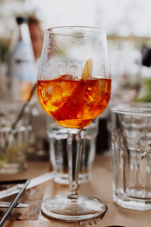 Free Close-up of a chilled Aperol Spritz on a table in Patmos, Greece, capturing the essence of summer relaxation. Stock Photo