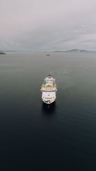 Serene aerial view of a cruise ship on calm waters near Patmos, Greece.