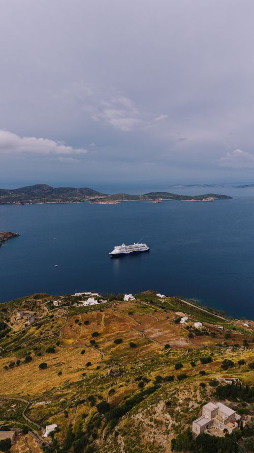Free Scenic aerial shot of a cruise ship in calm blue waters near Patmos Island, Greece. Stock Photo