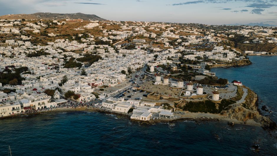 Best Private Helicopter Transfer from Paros to Santorini Review 2026 - Stunning aerial shot of Mykonos town with its famous white buildings and windmills during daytime in Greece.