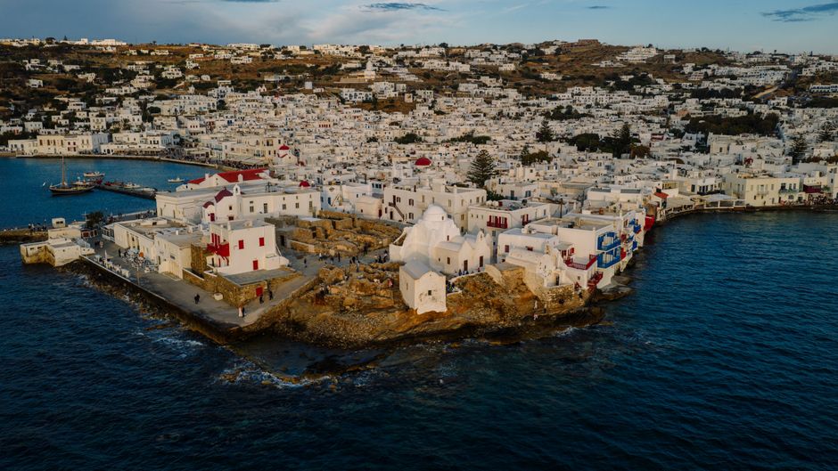 Incredible Private Helicopter Transfer from Folegandros to Santorini Review 2026 - Stunning aerial view of Mykonos town with whitewashed buildings and blue sea, showcasing Greek island architecture.