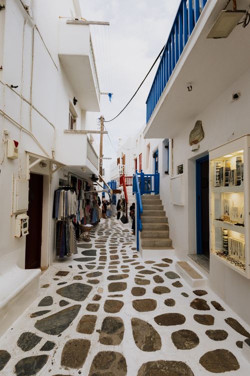 Free Explore the iconic whitewashed streets of Mykonos, Greece, with charming shops and vibrant atmosphere. Stock Photo