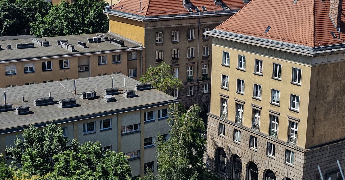 Aerial view of classic European residential architecture with red rooftops in a sunny summer day.