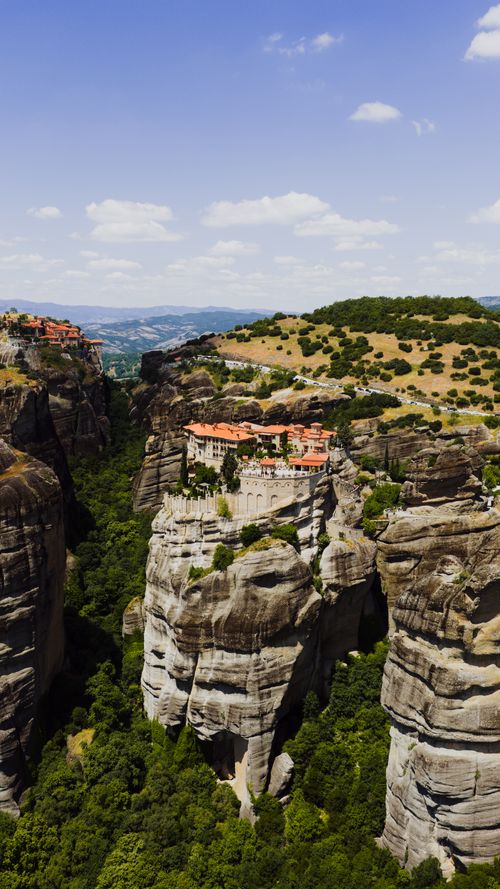 Free Stunning aerial image of Meteora monasteries perched atop giant rock formations in Greece. Stock Photo
