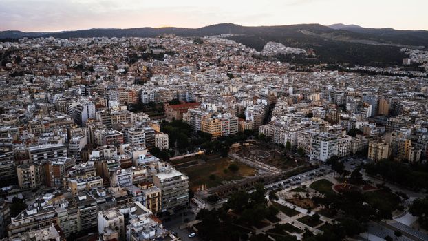 A sprawling aerial view of Thessaloniki, capturing the dense urban landscape under daylight.