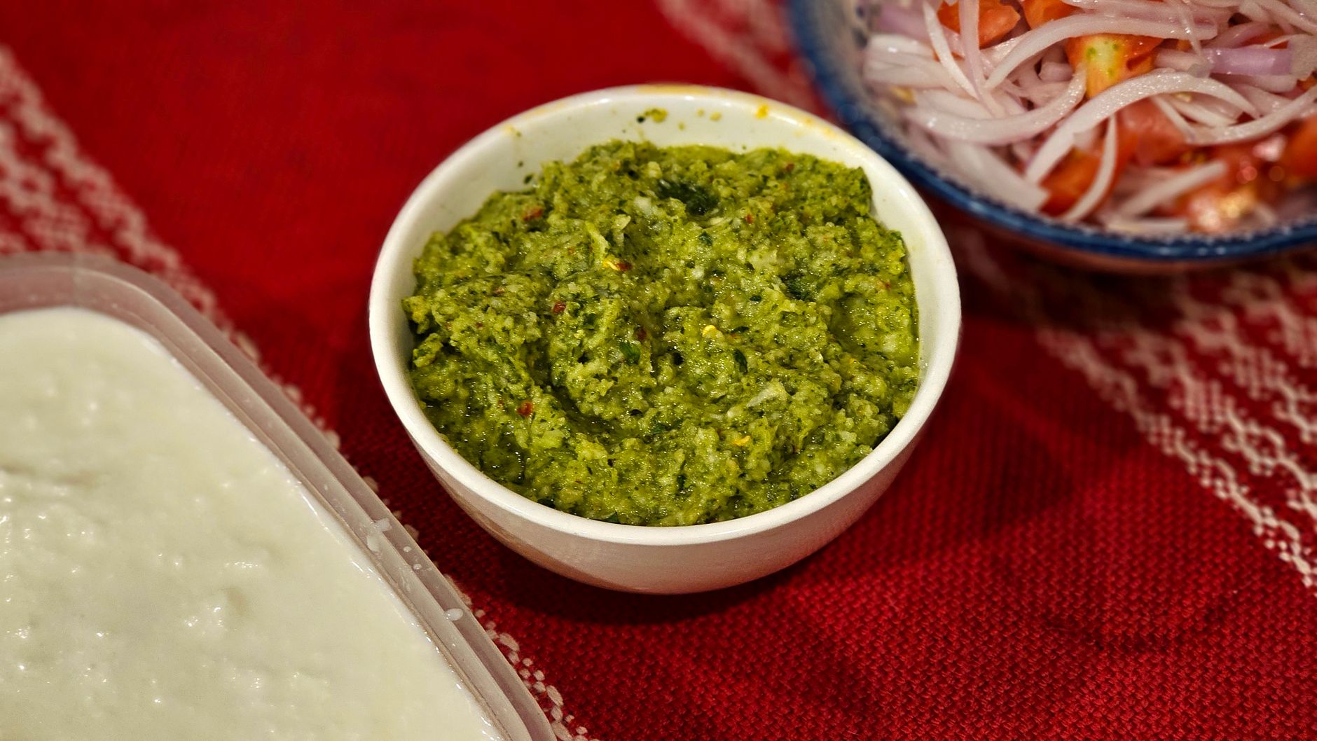 Apple chutney in a jar with fresh apples nearby