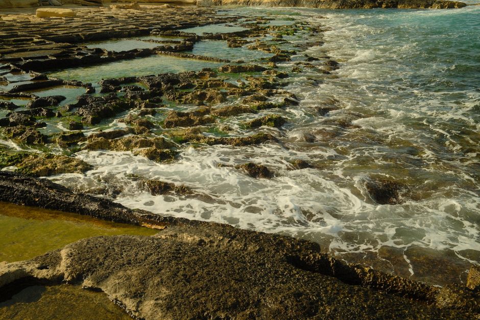 Waves crashing against the rocky coast of Malta on a windy day