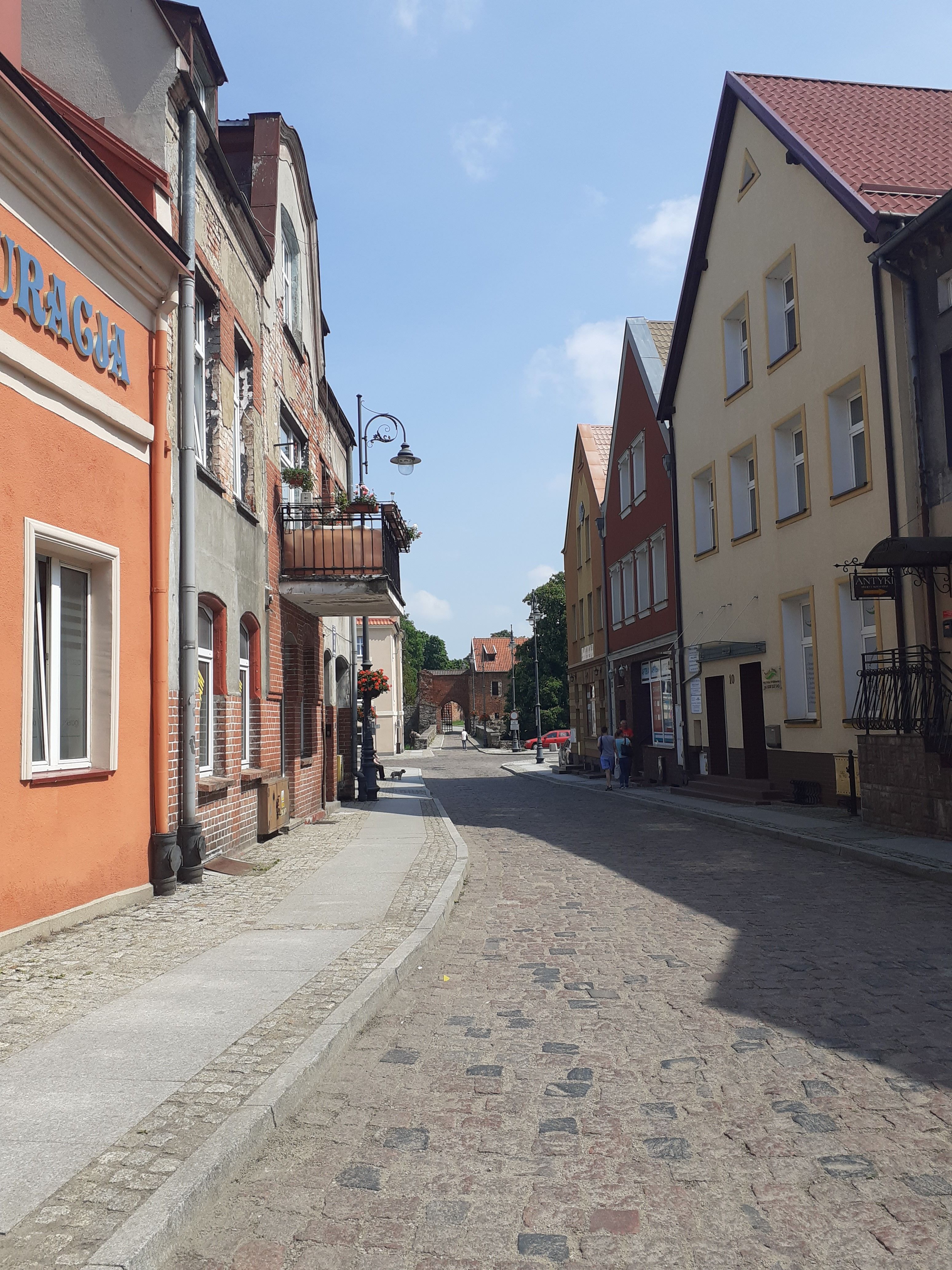 Charming cobblestone street with colorful historic buildings. Perfect for travel and architecture themes.