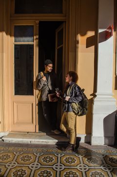 Students talking outside a campus building, photo by Irene Vega on Pexels