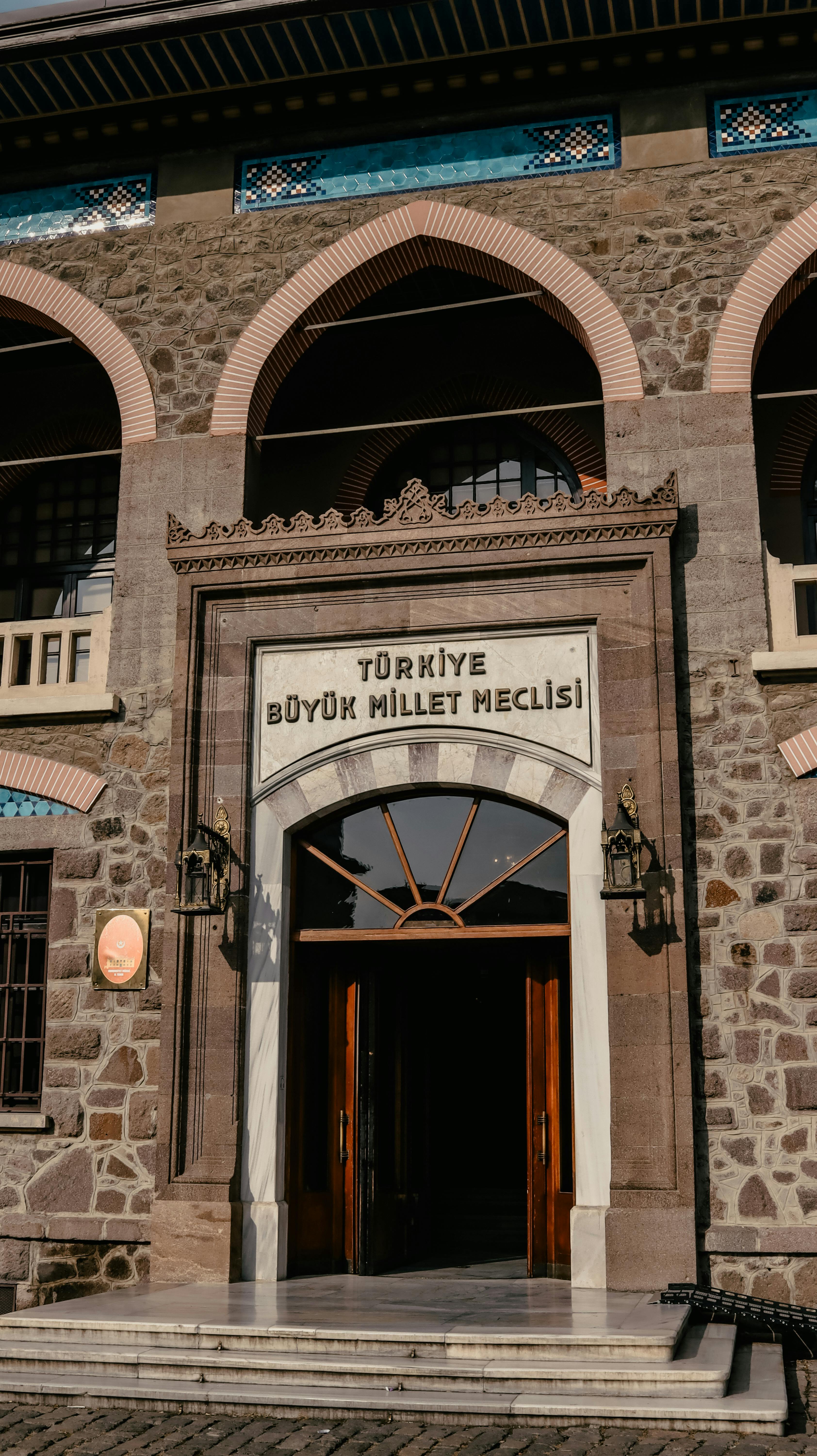 Front view of the historical Türkiye Büyük Millet Meclisi building entrance in Ankara.
