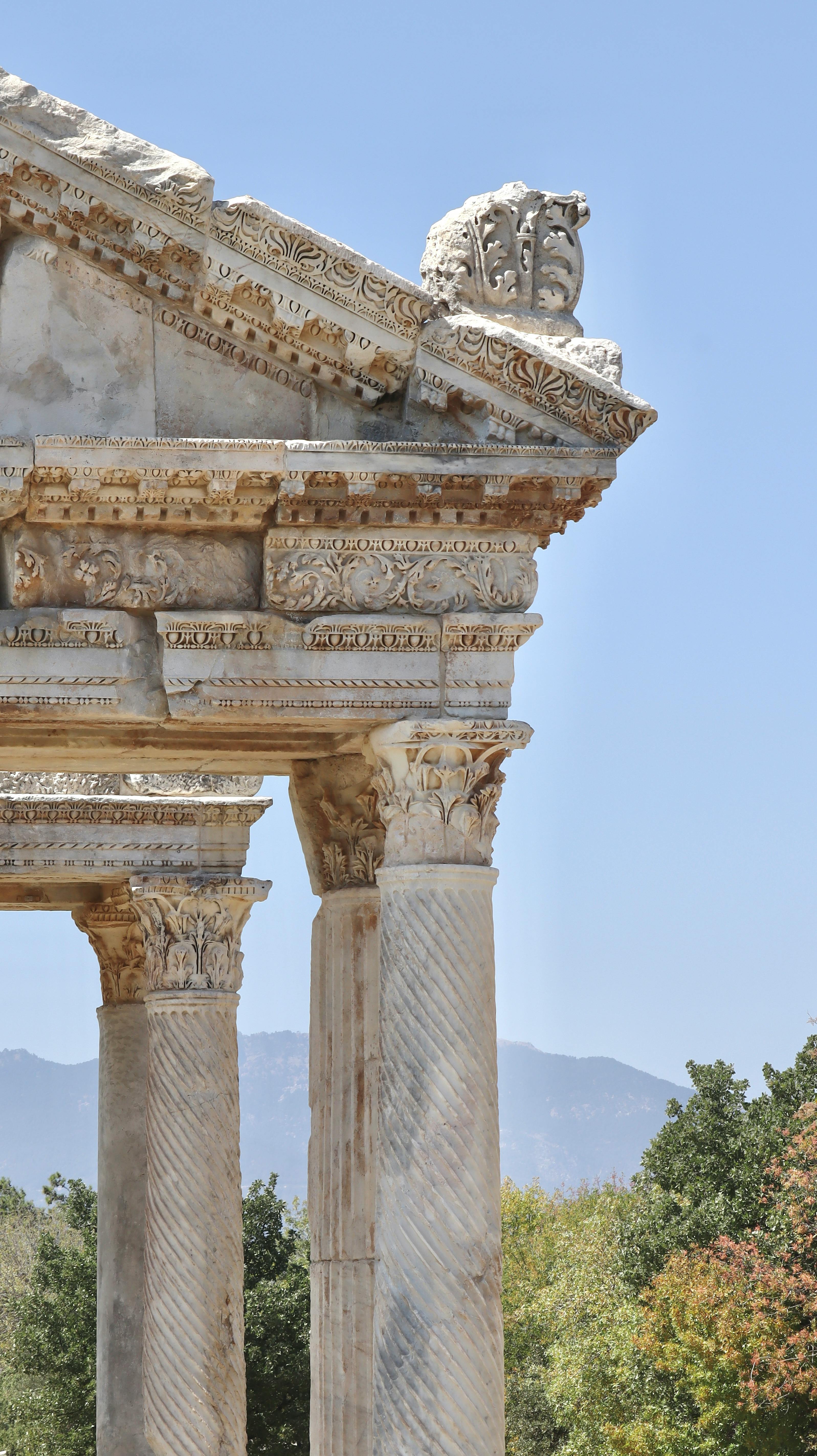 Close-up shot of ancient ornate columns in Aydın, Türkiye, showcasing intricate carvings.
