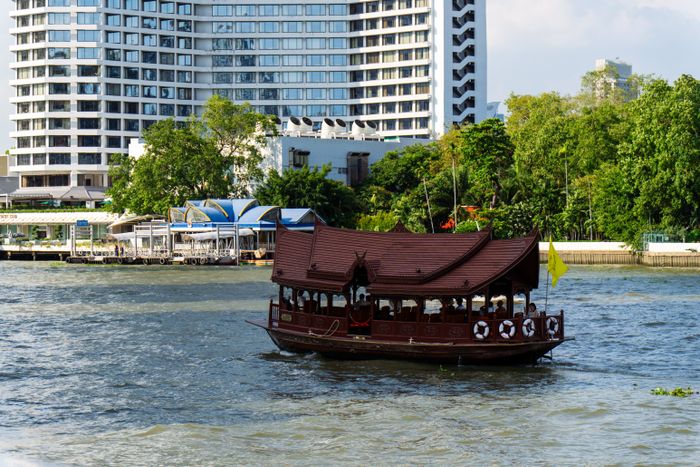Online dating Bangkok — a traditional boat along the Chao Phraya River near the city center