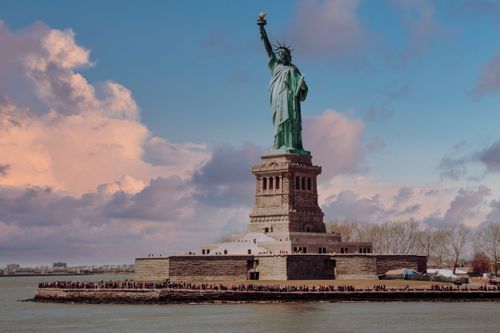 Free Captivating view of the Statue of Liberty with a vibrant sunset in New York City, USA. Stock Photo