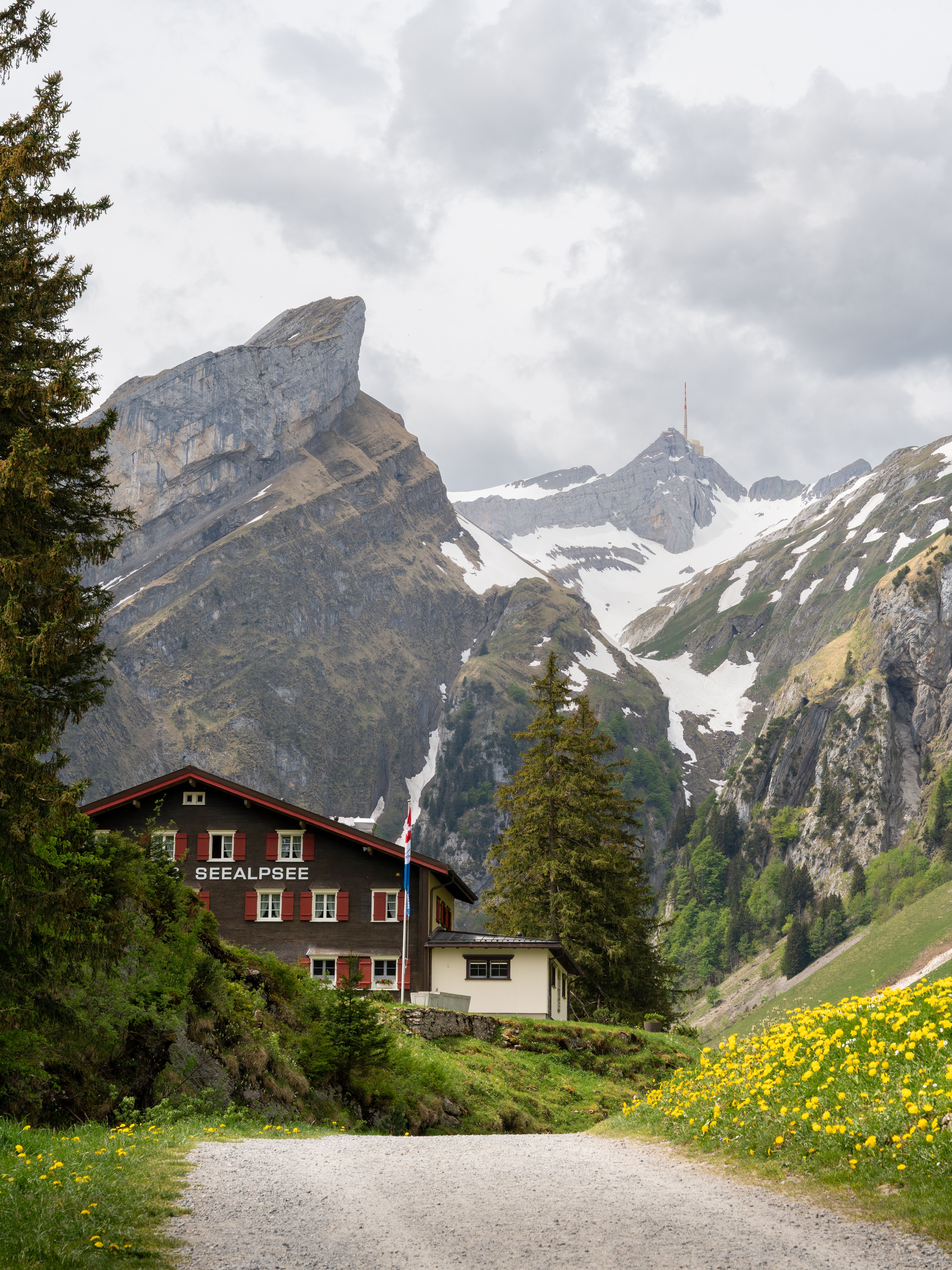 Charming mountain chalet in Schwende-Rüte, Switzerland, set against majestic alpine peaks.
