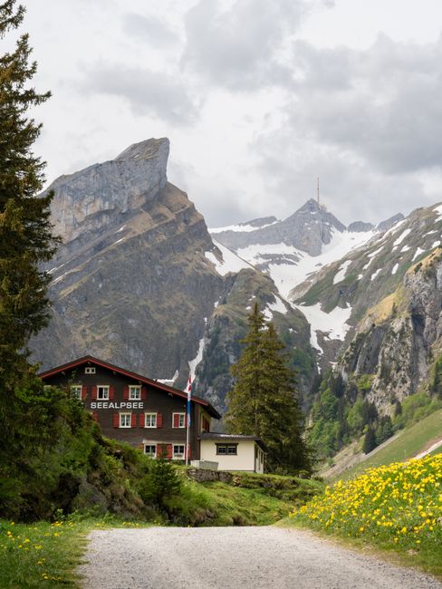 Charming mountain chalet in Schwende-Rüte, Switzerland, set against majestic alpine peaks.