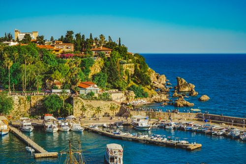 Free Explore Antalya's picturesque harbor with lush greenery and vibrant blue sea. Stock Photo