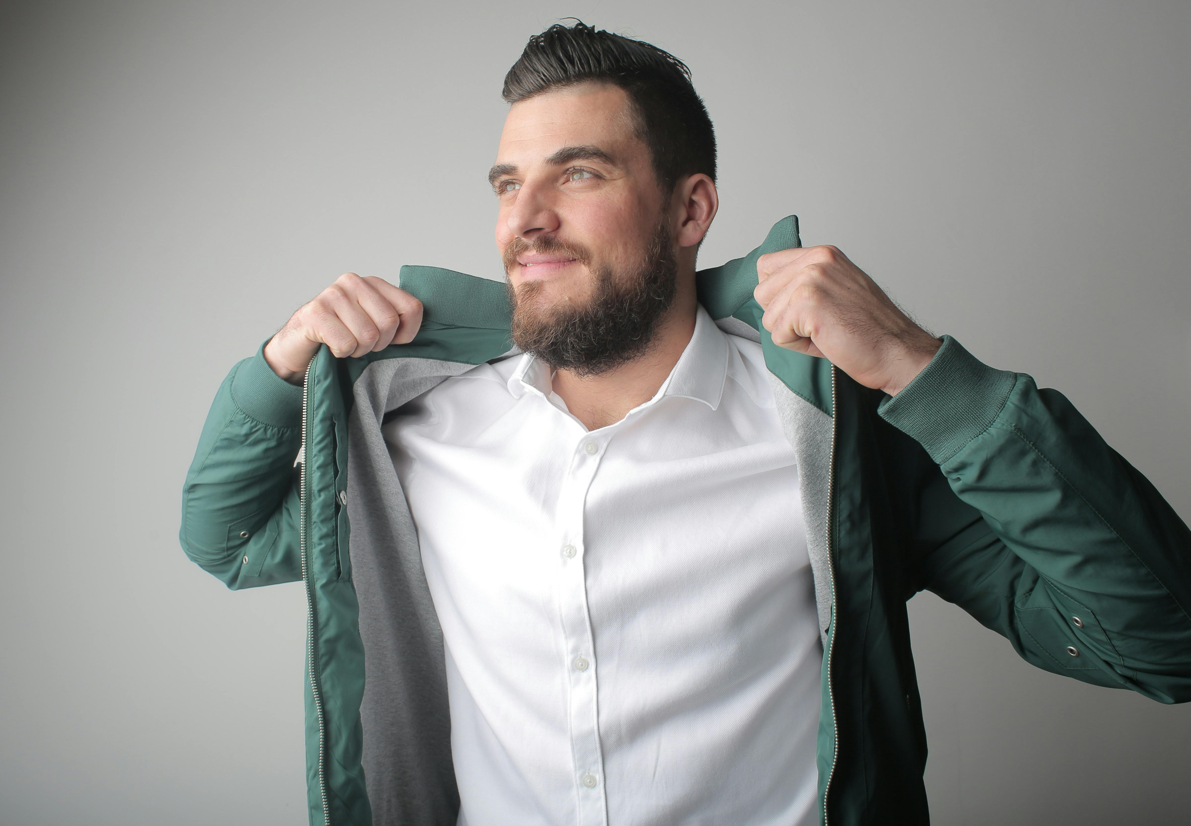 man in white shirt and green jacket