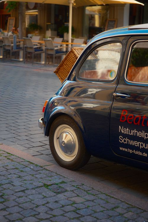 Classic Fiat 500 on a European Cobblestone Street · Free Stock Photo