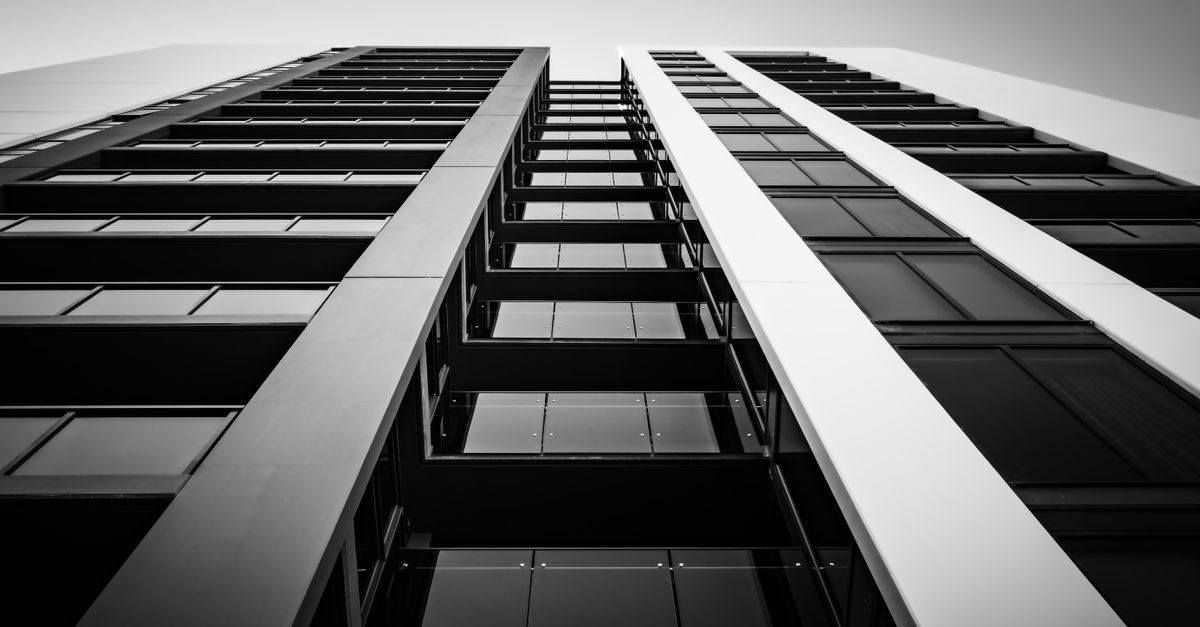 Black and white view of a modern building facade in New South Wales, Australia, showing sleek design and geometric lines.