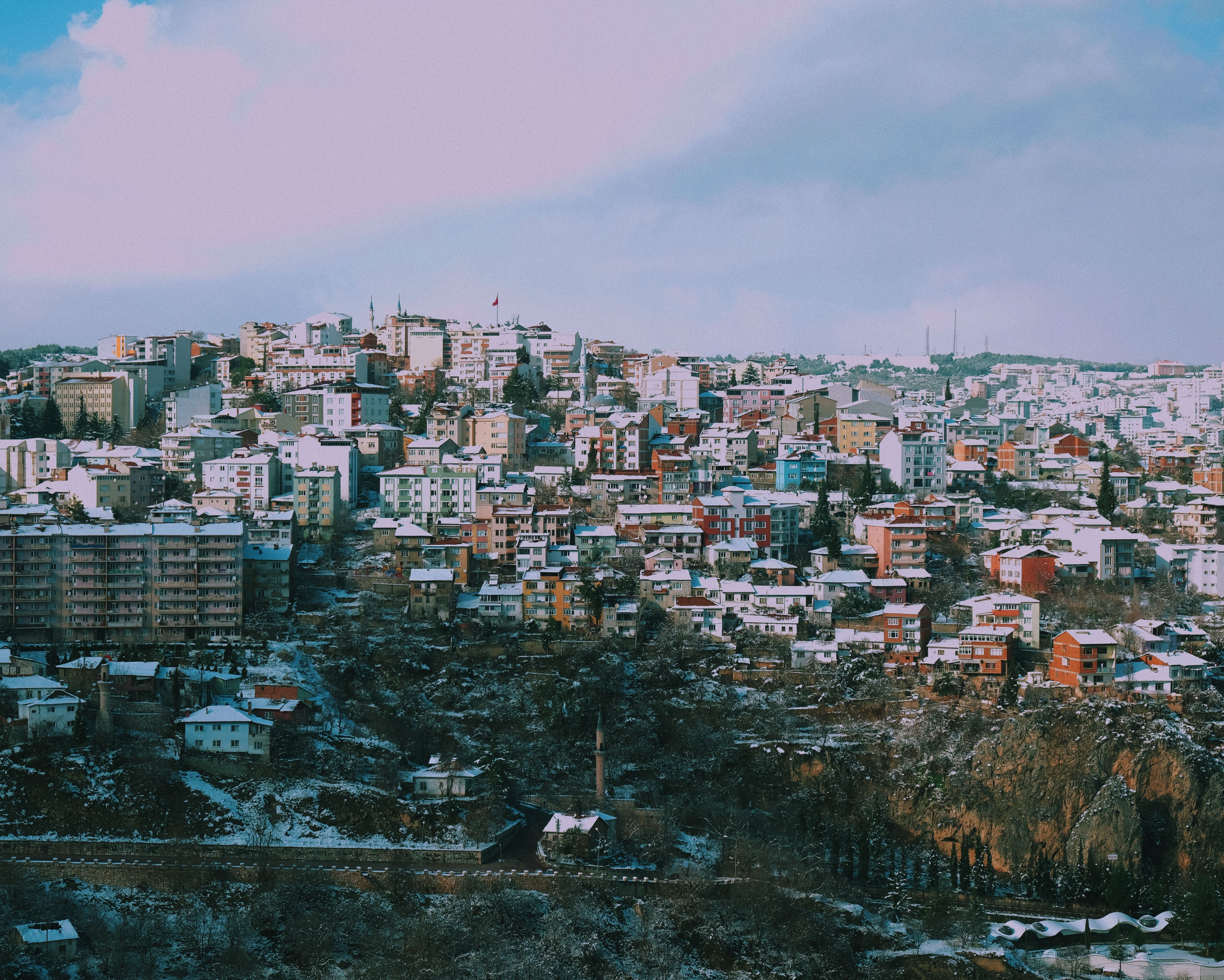 Aerial view of snow-covered Bilecik, Türkiye, showcasing vibrant architecture.