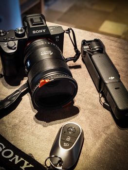 Premium camera equipment including Sony alpha with lens and tripod, perfect for photography enthusiasts.